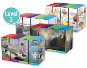 A collection of colorful boxed sets with different designs, marked as Level 2. The designs include cakes, historical photographs, fine art paintings of landscapes, and people in various settings. The boxes are arranged in three rows.